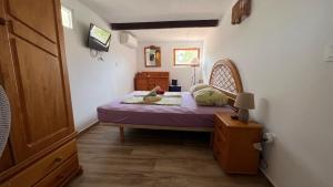 a small bedroom with a bed in a room at Casa Tanja in Teulada +10 photos