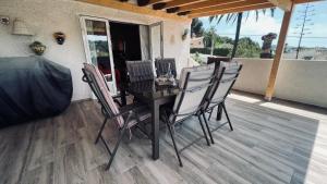 a table and chairs on a patio with a porch at Casa Tanja in Teulada