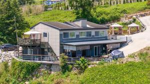 an aerial view of a house on a hill at Namhae JJhouse Pension in Namhae