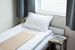 เตียงในห้องที่ Geo Hotel