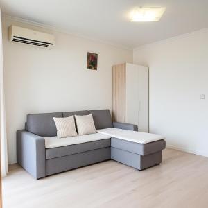 a couch with two pillows in a living room at Helios Seaview Apartment in Sveti Vlas