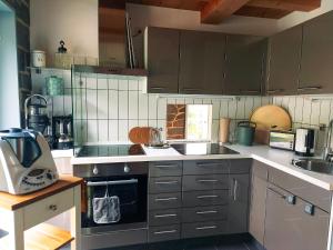a kitchen with a sink and a stove top oven at Ferienhaus NaturReich in Bad Berleburg