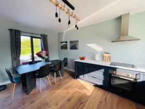 a kitchen with a table and chairs in a room at Tigín na mbó in Cloghane