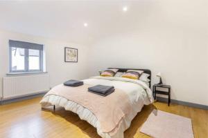 a bedroom with a large bed with two pillows on it at Zest Homes 87 Bridge Street in Leominster +8 photos