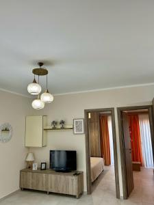 a living room with a television and a bed at Serenity in Kefalos