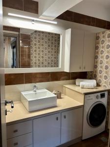 a kitchen with a sink and a washing machine at Serenity in Kefalos +24 photos