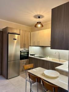 a kitchen with a table and a stainless steel refrigerator at Serenity in Kefalos