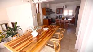 a wooden table and chairs in a kitchen at Villa Tholos Crete in Kavoúsion
