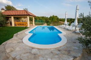 a swimming pool in a yard with a gazebo at Villa Magic with heated pool in Trbounje