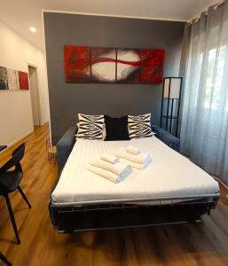 a bedroom with a bed with towels on it at Ancient Rome Colosseum modern and bright apartment in Rome