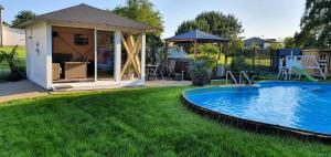 a backyard with a swimming pool and a gazebo at Fewo Traum in Neppermin