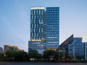 a tall building with many windows in a city at Atour X Hotel Xuefu Street Taiyuan South Railway Station in Taiyuan