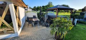 a patio with a gazebo and a table and chairs at Fewo Traum in Neppermin