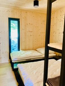 a room with three bunk beds and a window at Camping centra Shambhala in Lúčka