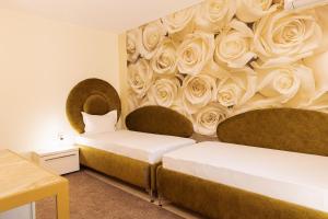Postel nebo postele na pokoji v ubytování Hotel Dafi