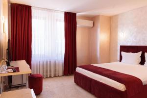 Postel nebo postele na pokoji v ubytování Hotel Dafi