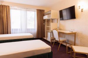Postel nebo postele na pokoji v ubytování Hotel Dafi