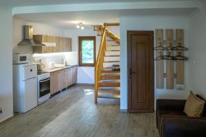 a kitchen with a staircase and a living room at Megafish Camp in Dunafalva