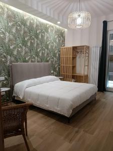 a bedroom with a large bed and a wall mural at PIANESE house 1 in Campobasso