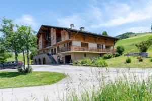 a house on a hill with a car parked in front at Studio 9 - La Palettaz in Crest-Voland