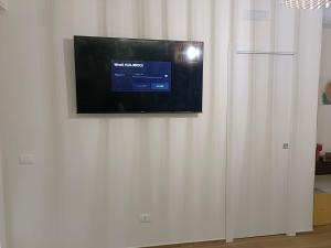 a flat screen tv hanging on a white wall at PIANESE house 1 in Campobasso