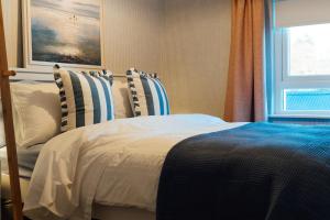 a bedroom with a bed with pillows and a window at No 66 Chapel Street in Cookstown