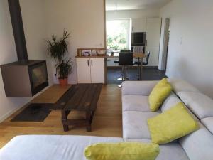 a living room with a couch and a fireplace at Grande maison bretonne entre campagne et mer in Saint-Pol-de-Léon +3 photos