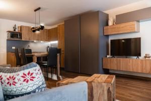 a living room with a couch and a dining room at Suite 6 posti Corbet - Piscina -Spa - gym-giardino in Champoluc