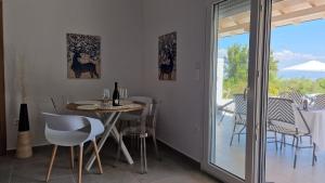 a dining room with a table and chairs at Anna Maria Mini Villa in Kriopigi