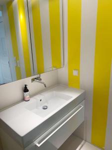 a bathroom with a white sink and a mirror at Apartament z balkonem in Sopot +5 photos