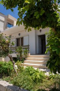 a white house with stairs in front of it at Anastasia mare home #A# in Rethymno Town