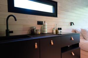 a bathroom with a sink and a counter with a sink at Chic Sauna Cabin Near the Sea - MULIN Cabin Nº05 in Tsitre +70 photos