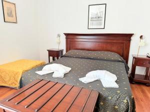 Letto o letti in una camera di Hotel Archimede Ortigia