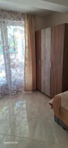 an empty room with a bed and a window at Къща за гости ЕДЕЛВАЙС in Chernomorets
