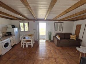 a living room with a couch and a table at Casa Amarela in Zambujeira do Mar