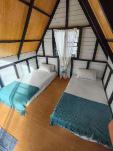a room with two beds in a attic at La Lune's Koh Tao in Ko Tao
