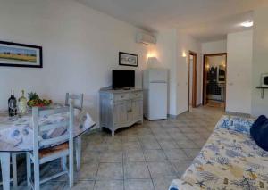 a living room with a table and a refrigerator at Apartment in Palau 44926 in Palau