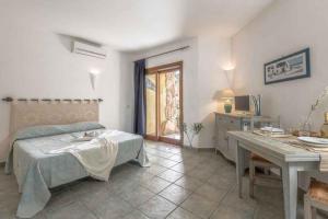 a bedroom with a bed and a table and a desk at Apartment in Palau 44926 in Palau +42 photos