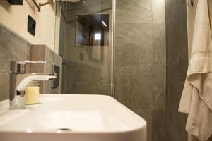 a bathroom with a white sink and a shower at La Casa nel Nebbiolo in Pont-Saint-Martin