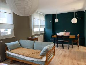 a living room with a couch and a dining room at Maison plages & centre à pieds - proche GR34 in Saint-Pol-de-Léon +47 photos