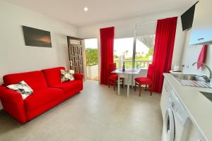 a living room with a red couch and a table at RedVelvet in Tacoronte
