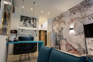 a room with a blue counter and a wall with a mural at Palazzo Sebeto in Naples