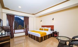 a bedroom with a bed and a window at Sumitel Sonam Lachung in Lachung +18 photos