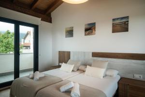 En eller flere senge i et værelse på Casa vacacional Mar y Cuera