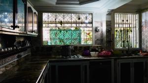 a kitchen with a sink and stained glass windows at Dar Surf & Ocean in Agadir