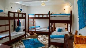 a room with four bunk beds in a room at Dar Surf & Ocean in Agadir