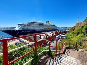 a cruise ship is docked at a harbor at 1A Cathedral Place - Cathedral Townhouses Cobh in Cobh