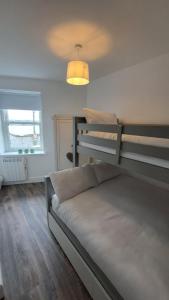 a bedroom with a bed and a bunk bed at 1A Cathedral Place - Cathedral Townhouses Cobh in Cobh