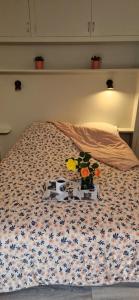 a bed with flowers on it with a bedspread at La Musardière in Saint-Oyen