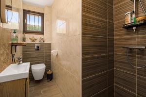 un bagno con un water e un lavandino di La Maison Ensoleillée - Avec jardin et terrasse ad Agde Altre 22 foto